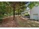 Large backyard with mature trees, landscaped garden and access to the house at 4309 King Valley Se Dr, Smyrna, GA 30082