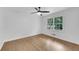 This airy bedroom boasts hardwood floors, a ceiling fan, and a large window overlooking the lush outdoors at 4309 King Valley Se Dr, Smyrna, GA 30082