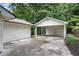 White house with a separate one car carport and concrete driveway at 4309 King Valley Se Dr, Smyrna, GA 30082
