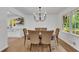 Dining room featuring chandelier lighting, a table with upholstered chairs, and natural light at 4309 King Valley Se Dr, Smyrna, GA 30082