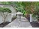 Exterior shot of the driveway leading up to a detached garage with a gated fence at 4309 King Valley Se Dr, Smyrna, GA 30082