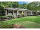 Charming single-story home featuring a manicured lawn, brick exterior, and inviting front porch at 4309 King Valley Se Dr, Smyrna, GA 30082