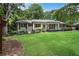 Charming single-story home featuring a manicured lawn, brick exterior, and inviting front porch at 4309 King Valley Se Dr, Smyrna, GA 30082