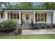 Charming covered front porch with stylish lighting and well-manicured landscaping at 4309 King Valley Se Dr, Smyrna, GA 30082