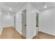 Hallway features wood floors, neutral walls, and doorways to various rooms providing seamless connectivity at 4309 King Valley Se Dr, Smyrna, GA 30082