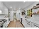 Bright, modern kitchen with white cabinets, subway tile, stainless appliances, and open shelving at 4309 King Valley Se Dr, Smyrna, GA 30082