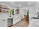 Kitchen features modern appliances, white cabinets, floating shelves and open to the dining room at 4309 King Valley Se Dr, Smyrna, GA 30082