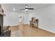 Bright living room featuring a black brick fireplace, hardwood floors, and modern ceiling fan at 4309 King Valley Se Dr, Smyrna, GA 30082