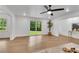 Bright living room with hardwood floors, large windows, and contemporary ceiling fan at 4309 King Valley Se Dr, Smyrna, GA 30082