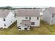 An aerial view of the home's backyard with a covered patio, well-kept lawn, and exterior facade at 895 Garnet Dr, Acworth, GA 30101