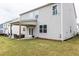 Backyard featuring a covered patio with outdoor furniture, and manicured lawn on this two-story home at 895 Garnet Dr, Acworth, GA 30101