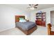 Comfortable bedroom with a wooden bed, ceiling fan, and a large bookshelf at 895 Garnet Dr, Acworth, GA 30101
