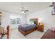 Well-lit bedroom offers a ceiling fan, a wooden bed, and a serene atmosphere at 895 Garnet Dr, Acworth, GA 30101