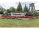 Welcome to Wildbrooke, stone entrance with flowering plants at 895 Garnet Dr, Acworth, GA 30101