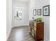 Stylish entryway featuring a charming accent cabinet, hardwood floors, and a bright white door, creating an inviting ambiance at 895 Garnet Dr, Acworth, GA 30101
