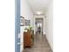 Inviting entryway featuring hardwood floors, framed art, and a charming accent cabinet offering a warm welcome into the home at 895 Garnet Dr, Acworth, GA 30101