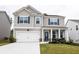 Charming two-story home with a well-maintained lawn, two car garage, and a welcoming front porch at 895 Garnet Dr, Acworth, GA 30101