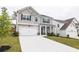 Charming two-story home with a two car garage, a well-maintained lawn, and beautifully designed facade at 895 Garnet Dr, Acworth, GA 30101