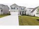 Charming two-story home featuring a two-car garage, manicured lawn, and a welcoming entrance, offering great curb appeal at 895 Garnet Dr, Acworth, GA 30101