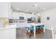 Well-lit kitchen featuring stainless steel appliances, white cabinets, and a central island with seating for casual dining at 895 Garnet Dr, Acworth, GA 30101