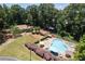 Aerial view showcases the community pool and clubhouse nestled among lush trees at 1120 Highland Bluff Se Dr, Atlanta, GA 30339
