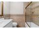 Bathroom featuring tile walls, a glass shower door, and a sink with modern fixtures at 1120 Highland Bluff Se Dr, Atlanta, GA 30339
