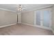 Serene bedroom with double doors, a ceiling fan, and soft carpeting creates a comfortable retreat at 1120 Highland Bluff Se Dr, Atlanta, GA 30339