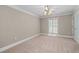 Bedroom with neutral carpet, white trim, ceiling fan, and a window with natural light at 1120 Highland Bluff Se Dr, Atlanta, GA 30339