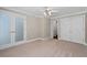 Bedroom with neutral carpet, doors to hallway and closet, ceiling fan, and white trim at 1120 Highland Bluff Se Dr, Atlanta, GA 30339