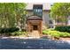 Beautiful stone building entrance with a covered walkway surrounded by lush landscaping at 1120 Highland Bluff Se Dr, Atlanta, GA 30339
