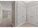 Hallway with double doors, carpet and entrance to a well-lit room with a ceiling fan at 1120 Highland Bluff Se Dr, Atlanta, GA 30339