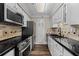 Updated kitchen showcasing stainless steel appliances, modern cabinets, and sleek black countertops at 1120 Highland Bluff Se Dr, Atlanta, GA 30339