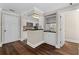 Cozy kitchen with black countertops, white cabinets, and wine rack, leading to the entryway at 1120 Highland Bluff Se Dr, Atlanta, GA 30339