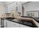 Granite countertops and white cabinetry complement the black appliances and decorative backsplash at 1120 Highland Bluff Se Dr, Atlanta, GA 30339