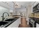 Spacious kitchen showcasing stainless steel appliances, black sink, and view into the living room at 1120 Highland Bluff Se Dr, Atlanta, GA 30339