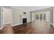 Spacious living room featuring a fireplace, hardwood floors, and a sliding glass door to outdoor balcony at 1120 Highland Bluff Se Dr, Atlanta, GA 30339