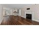Open-concept living room with hardwood floors and fireplace, providing a seamless flow throughout the home at 1120 Highland Bluff Se Dr, Atlanta, GA 30339