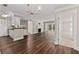 Open-concept living space with hardwood floors, fireplace, and connecting modern kitchen at 1120 Highland Bluff Se Dr, Atlanta, GA 30339