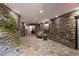 Lobby area with stone walls, potted plants, a painting, and chair at 1120 Highland Bluff Se Dr, Atlanta, GA 30339