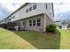 This backyard features a small patio area that is perfect for outdoor seating and relaxation at 2169 Lanier Harbor Pt, Buford, GA 30518