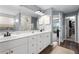 Open bathroom featuring dual sinks and a walk-in closet at 2169 Lanier Harbor Pt, Buford, GA 30518