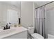 Cozy bathroom features a shower-tub combo with a decorative curtain, and a white single sink vanity at 2169 Lanier Harbor Pt, Buford, GA 30518