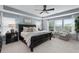 Bright main bedroom featuring a tray ceiling, ceiling fan and many windows at 2169 Lanier Harbor Pt, Buford, GA 30518