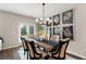 Dining room with stylish chairs, wood table, decorative chandelier, and natural light at 2169 Lanier Harbor Pt, Buford, GA 30518