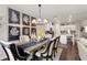 Elegant dining area with wood table, decorative chandelier, and modern botanical wall art at 2169 Lanier Harbor Pt, Buford, GA 30518