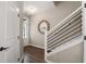 Entryway featuring wood-look flooring, a staircase with modern black railings, and a stylish round mirror at 2169 Lanier Harbor Pt, Buford, GA 30518