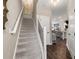 Inviting entryway featuring a staircase with wooden floors and modern black and white railings at 2169 Lanier Harbor Pt, Buford, GA 30518