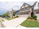 Attractive townhome with a two-car garage, landscaping, and a well-maintained lawn at 2169 Lanier Harbor Pt, Buford, GA 30518