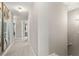 Hallway with neutral walls, carpet flooring and decorative mirrors, leading to other rooms at 2169 Lanier Harbor Pt, Buford, GA 30518