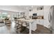 Open-concept kitchen featuring a large island with seating, white cabinets, stainless steel appliances, and modern lighting at 2169 Lanier Harbor Pt, Buford, GA 30518